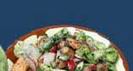 Fattouch: Medley of fresh vegetables served with tangy lemon dressing and topped with crisped bread.