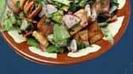 Fattouch: Medley of fresh vegetables served with tangy lemon dressing and topped with crisped bread.