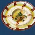 Hommos: Mashed garbanzo beans, mixed with tahini and lemon, topped with extra virgin olive oil.